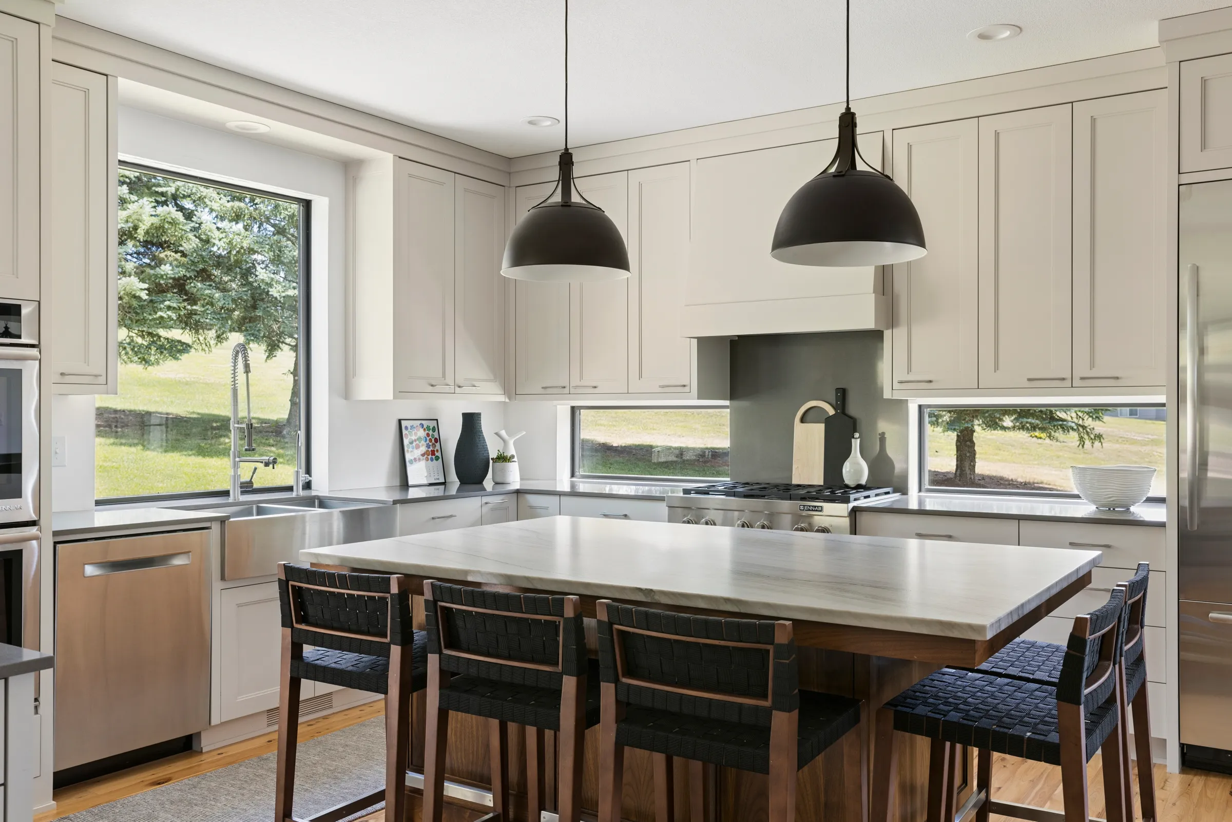 Wide view of the finished Lakeville kitchen showing the connection to the adjoining main-level spaces