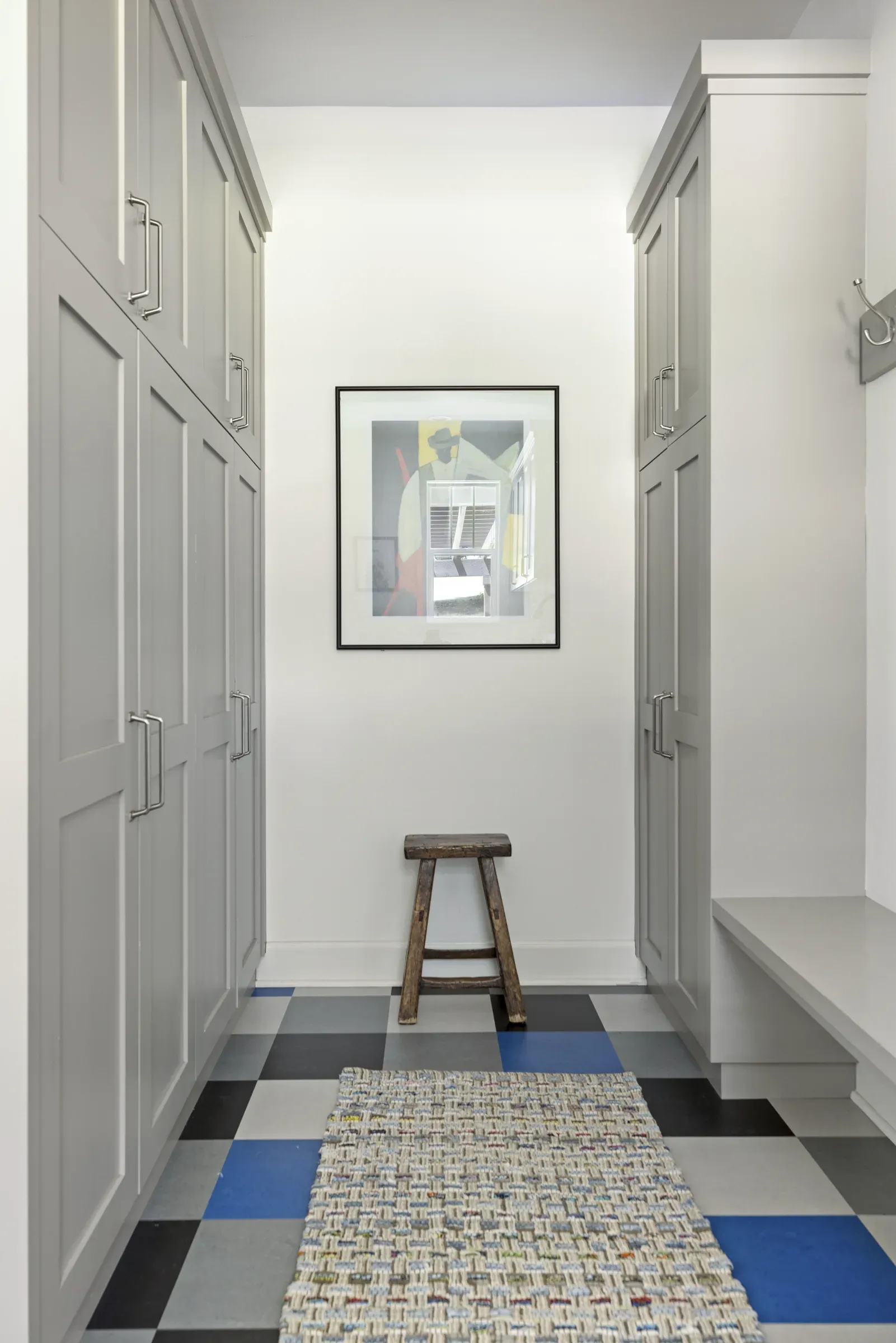 Tall paint-grade poplar cabinetry and laminate work surface in a Lakeville laundry room and mudroom remodel by Honey-Doers Remodeling